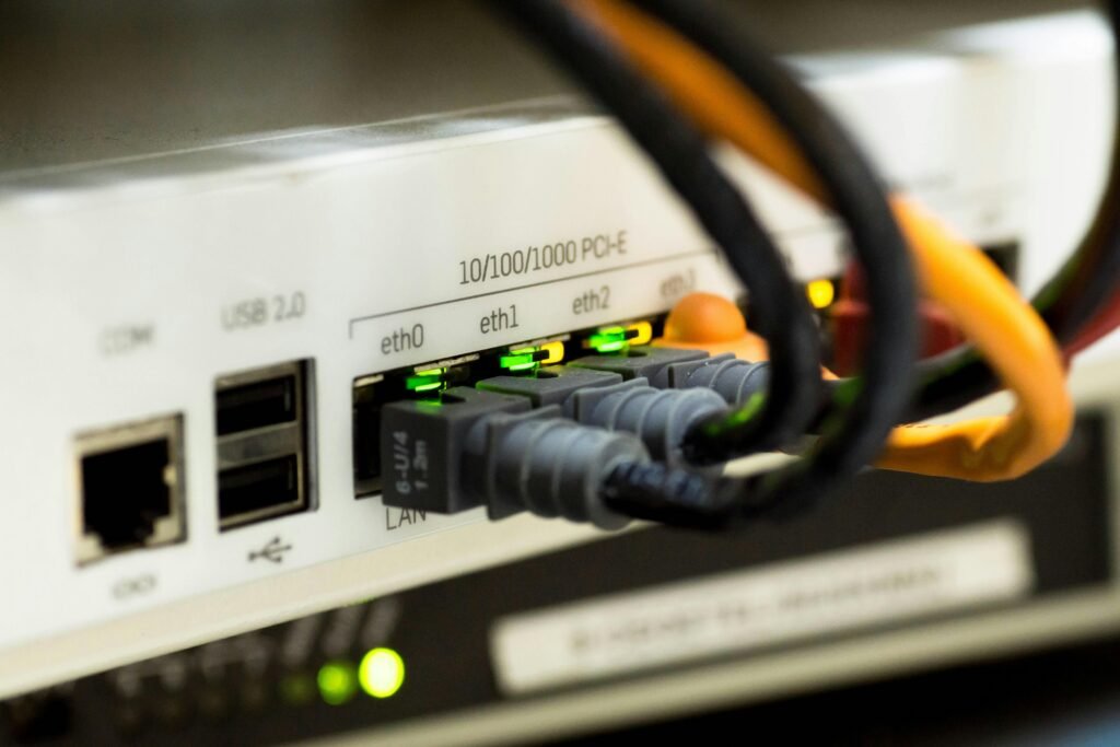 Detailed close-up of ethernet cables and network connections on a router, showcasing modern technology.